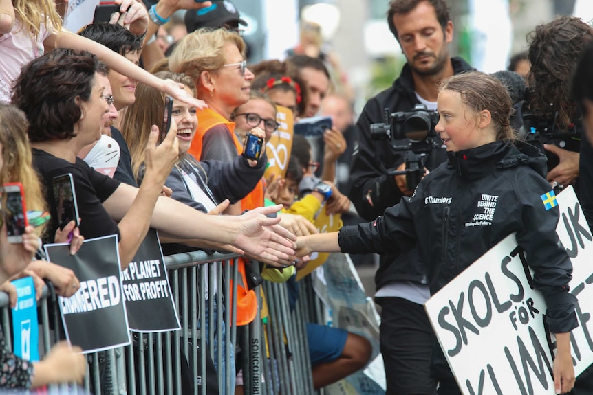 Greta Thunberg, a 16-year-old Swedish climate activist, greets supporters as she arrives in New York, Wednesday, August 28, 2019