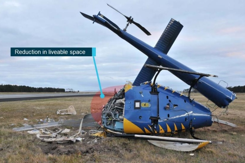 A helicopter crashed on its side, an illustration shows how much of the "liveable space" was destroyed