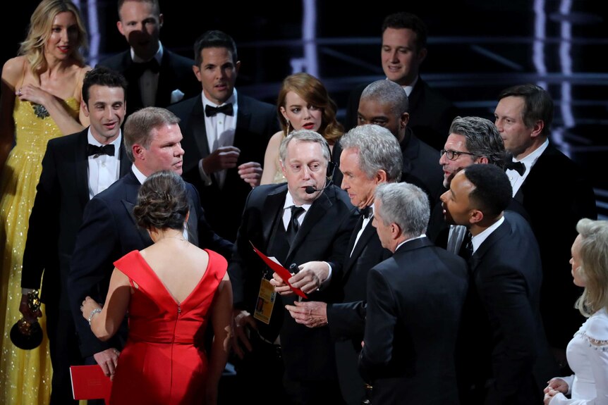 Warren Beatty holds the card for the Best Picture Oscar awarded to Moonlight.