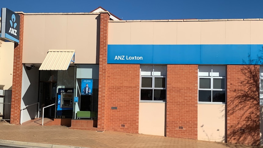 A brown brick building with blue ANZ signage on a main street in regional SA