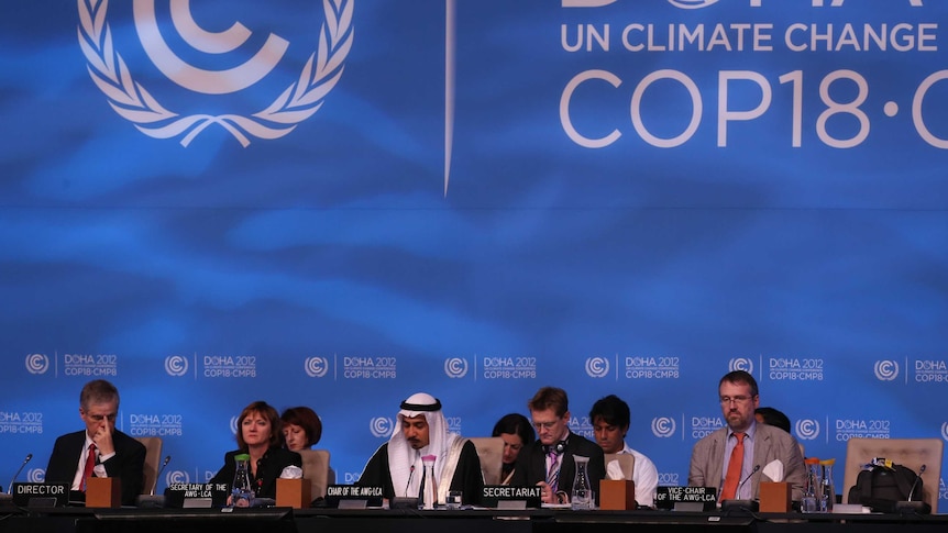 Delegates attend the last day of the UN climate talks in Doha.