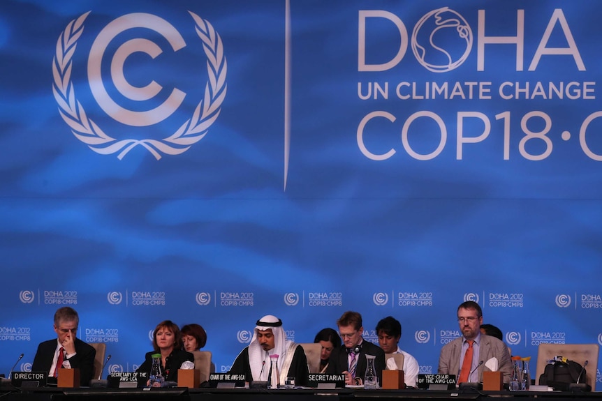 Delegates attend the last day of the UN climate talks in Doha.