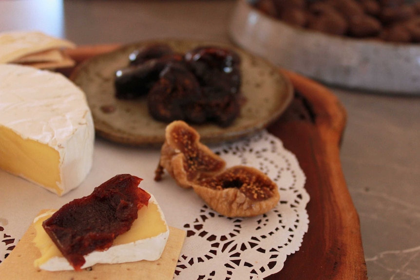 Cheese and dried fruit on a wooden board