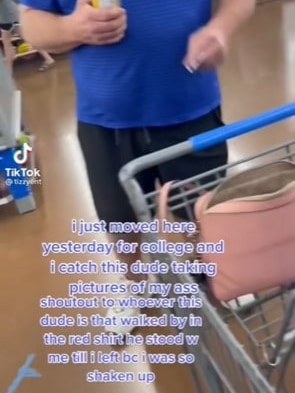 A man in shorts and a tshirt stands in a supermarket