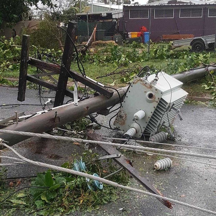 A power pole crashed to the ground with wires low enough to touch