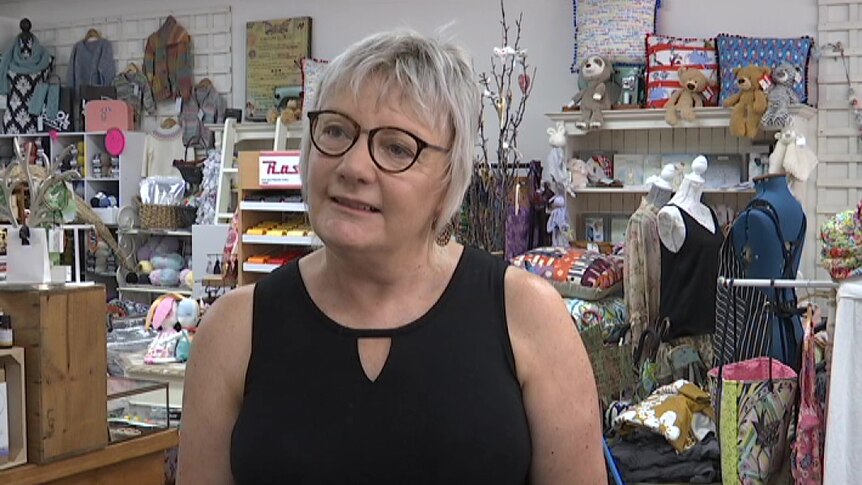 Chris Richardson stands in her shop.