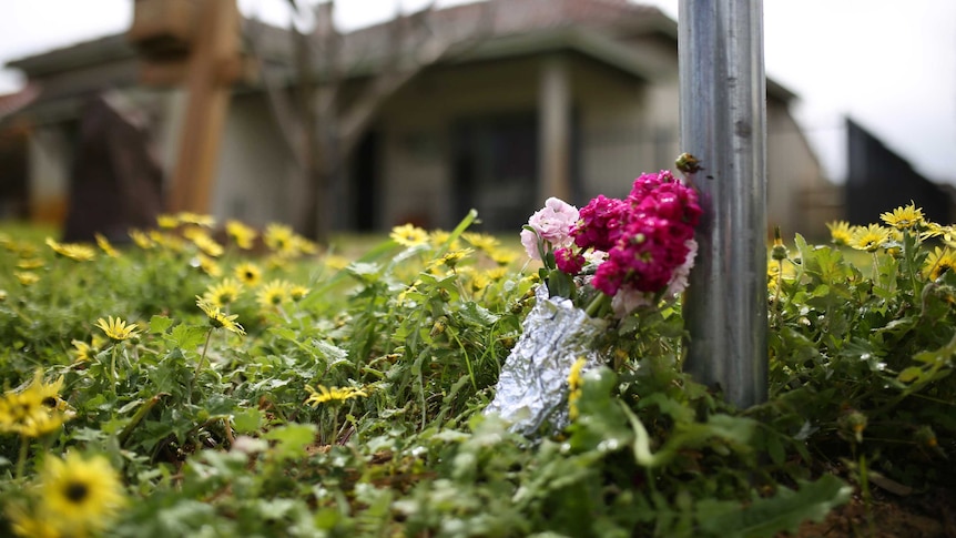A bunch of pink flowers lies on the ground outside a house on Coode Street in the north-eastern Perth suburb of Bedford.