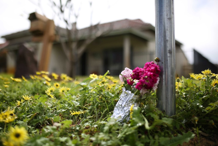 A bunch of pink flowers lies on the ground outside a house on Coode Street in the north-eastern Perth suburb of Bedford.