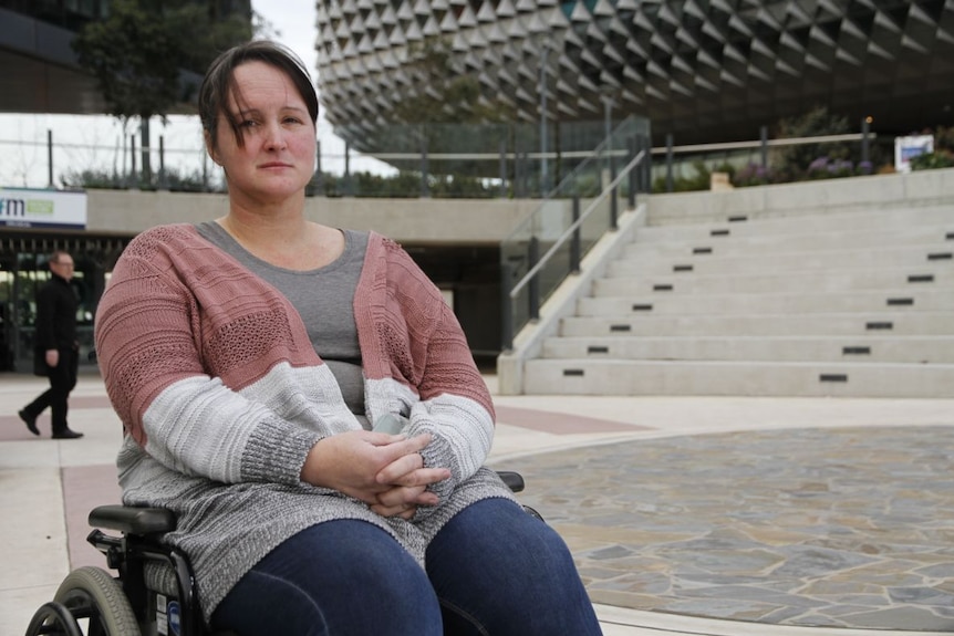 Sue Parker sits in a wheelchair.