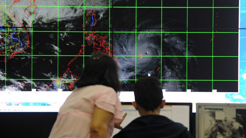 Meteorologists monitor and plot the direction of Super Typhoon Hagupit