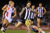 On the press ... Dane Swan launches a kick on goal