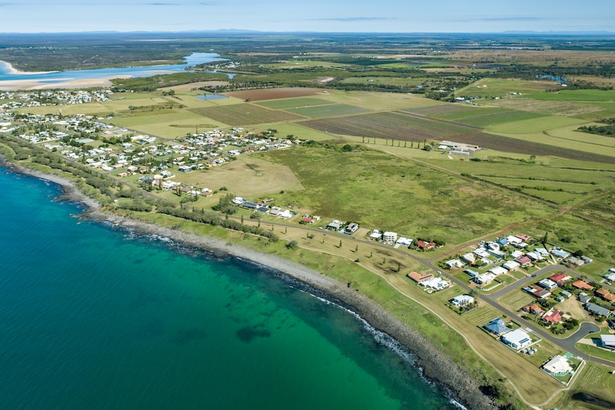 An aerial view of houses along the coastline.