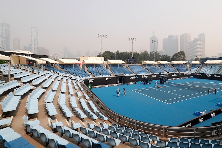 A tennis court is seen in smokey air
