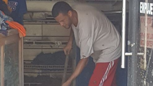 Man cleans up in Puerto Rico after Hurricane Maria.
