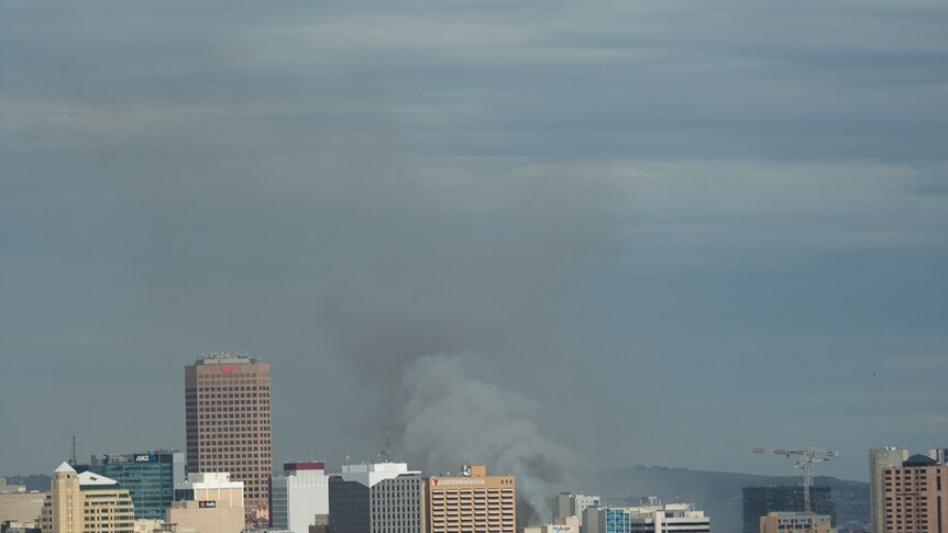 Smoke blankets Adelaide from a fire in Hindley Street.