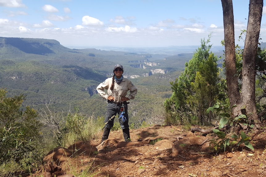 Sheridan Lawton standing at the top of Battleship Spur, hands on hips, panoramic views of the gorge behind.