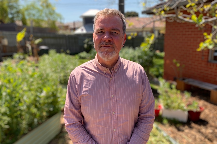 A man standing in a garden.