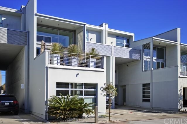 A white condo with two storeys. 