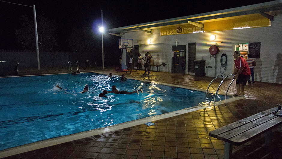 Aaron Jacobs supervises children swimming in Fitzroy Crossing's public pool at midnight.