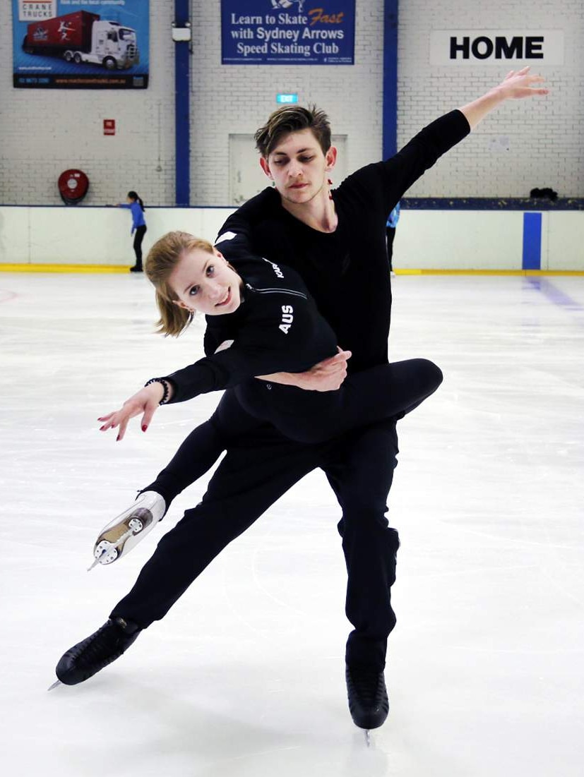 Two people ice skating.