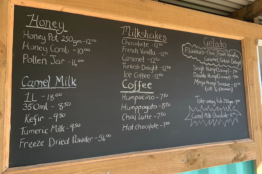 A chalk board with dairy menu items and prices written on it.