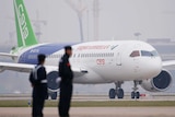A Chinese C919 passenger jet sits on a runway in Shanghai.