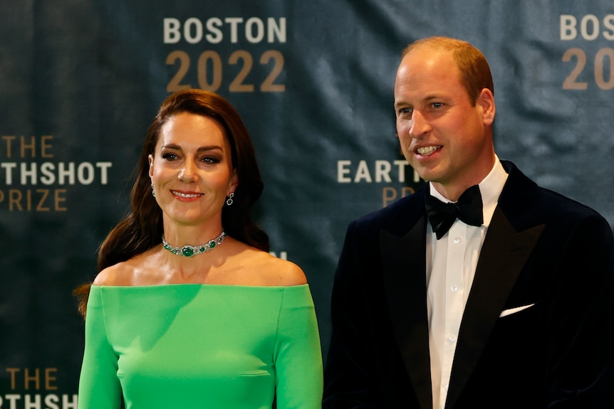 Princess Catherine wearing a green dress and Prince William wearing a black suit with a bow tie