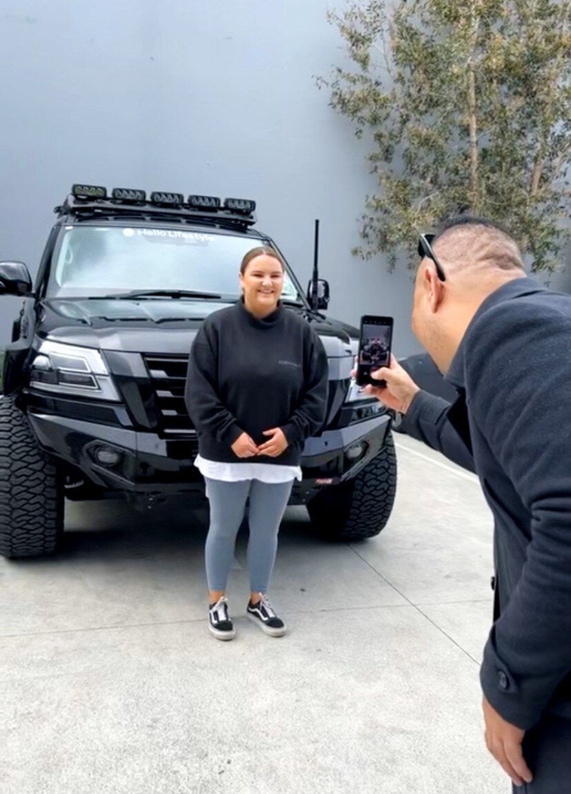 Amelia Conway poses for a photo with her new car