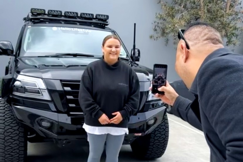 Amelia Conway poses for a photo with her new car