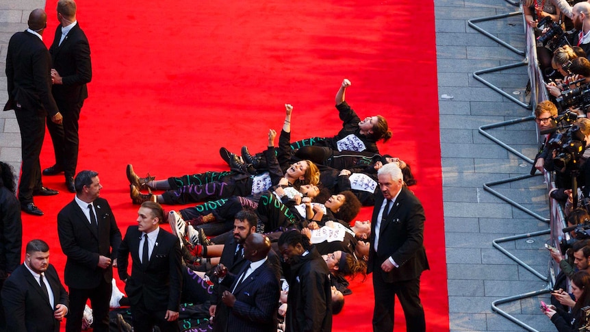 The feminist group, Sisters Uncut, lie on the red carpet during a protest at the Suffragette premiere in London.