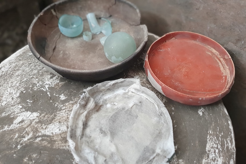 three bowls on a decorative table unearthed in Pompeii