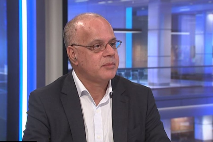 Man sitting in the ABC studio speaks during an interview.