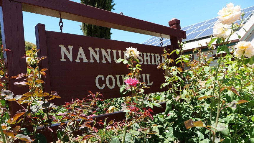 Roses in front of a sign for the Nannup Shire Council
