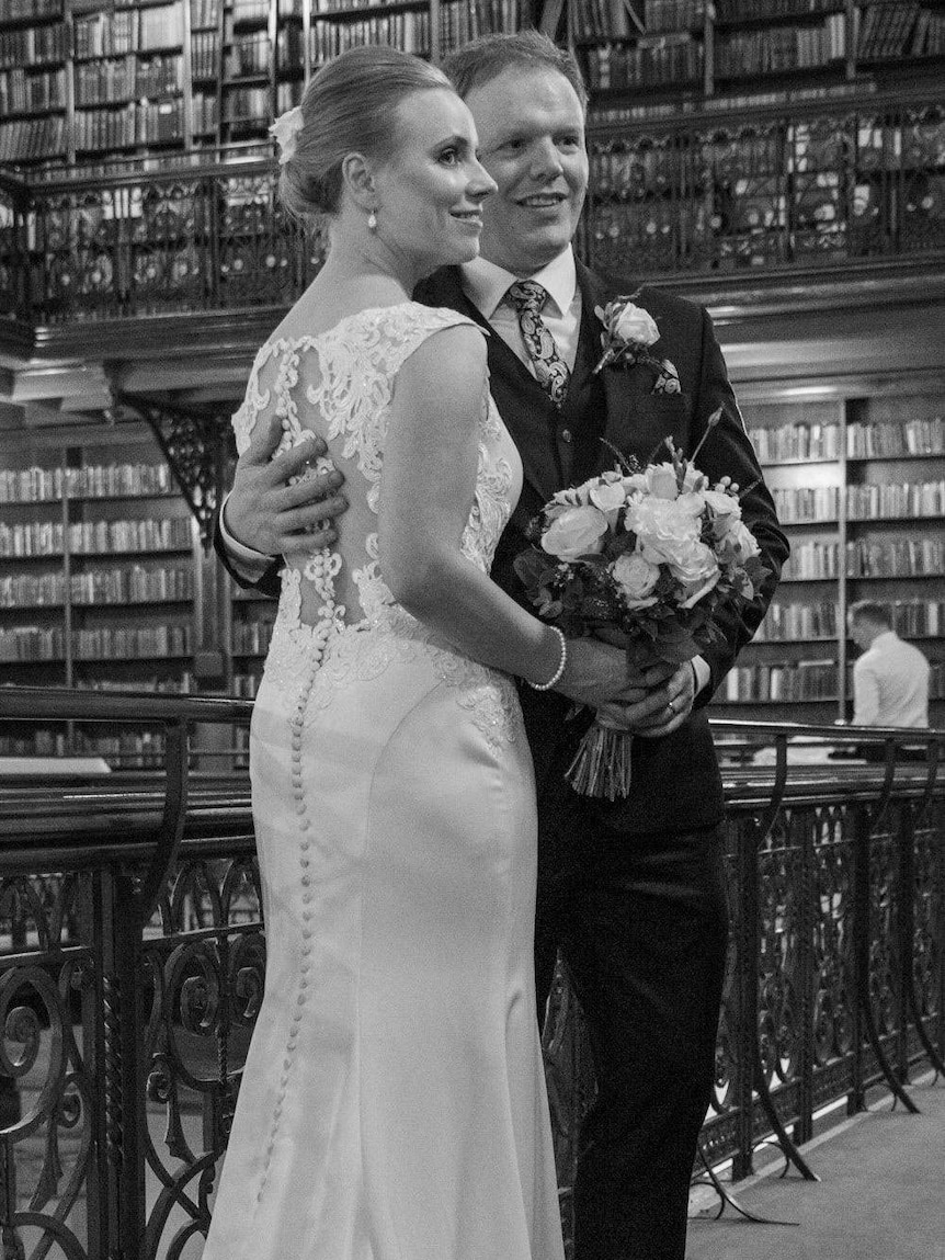 Louise Beaston wears a white wedding dress and Richard Boyle wears a suit