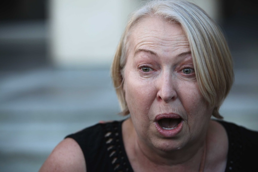 A close up of a woman expressing shock and joy