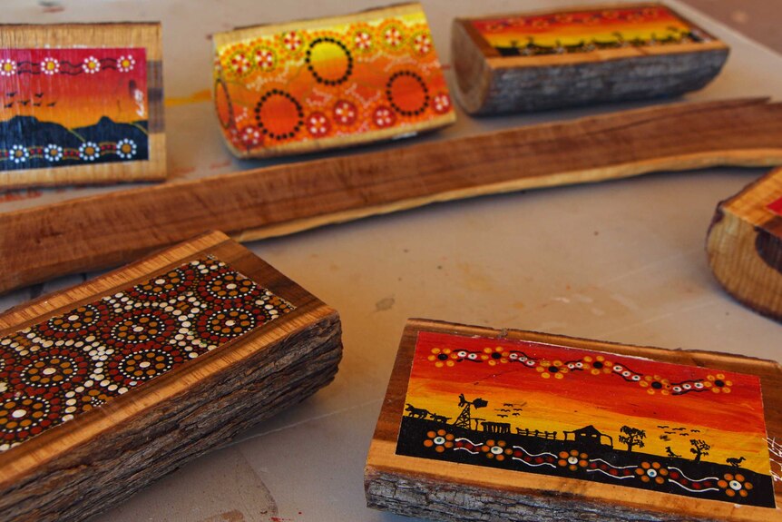 Indigenous painting on wooden stumps