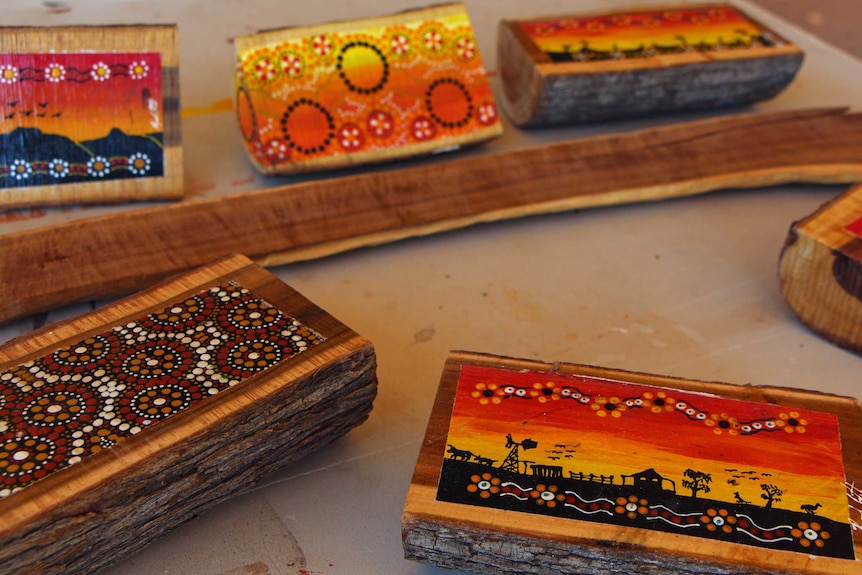 Indigenous painting on wooden stumps