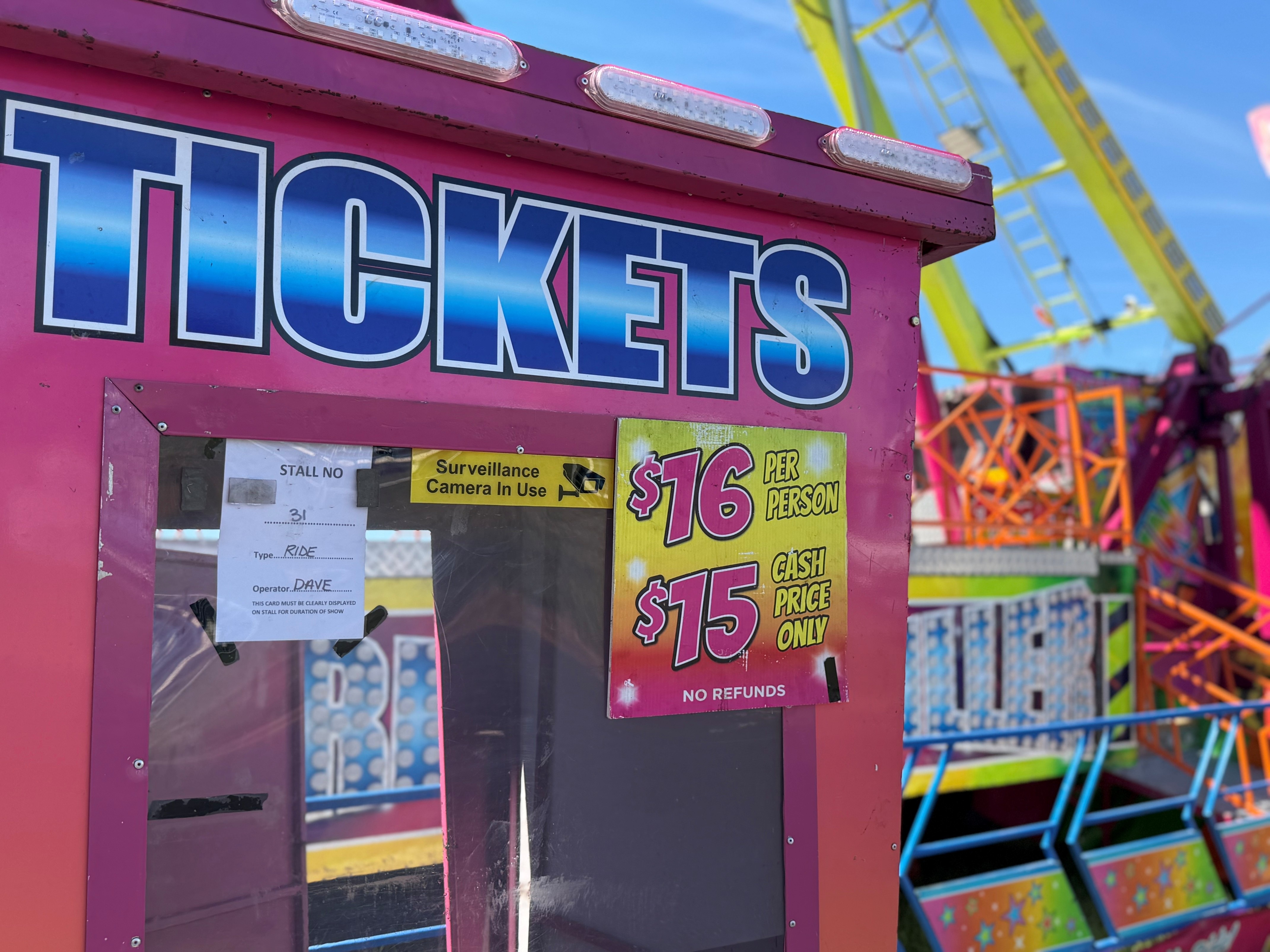 Bright pink box with ticket prices on it