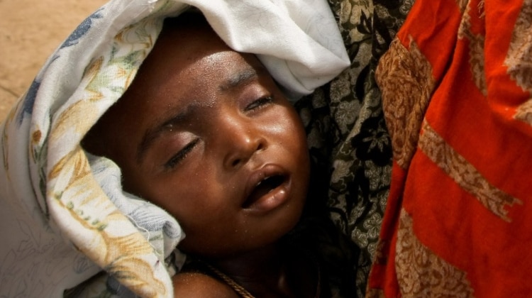 A woman holds her severely malnourished child in a camp for internally displaced people in Mogadishu.