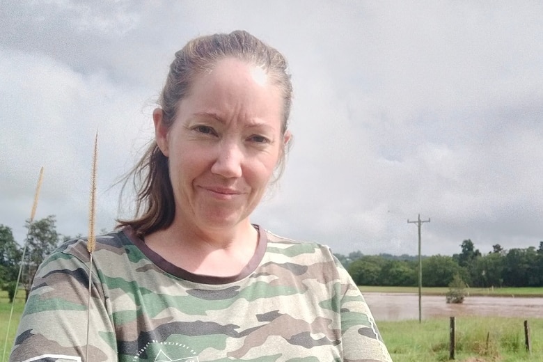 Nikki standing in front of flood water