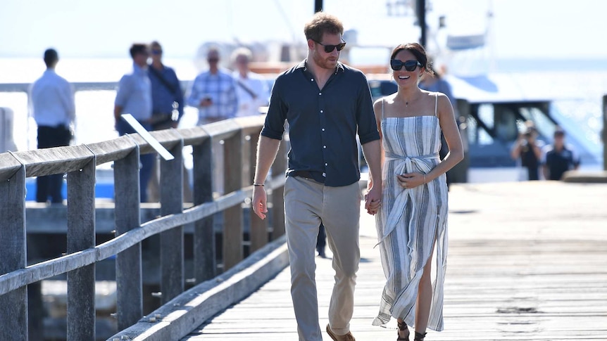 Prince Harry and his wife Meghan walk at Kingfisher Bay Resort on Fraser Island.