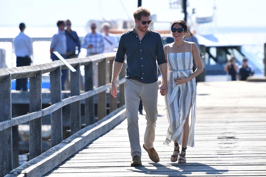 Prince Harry and his wife Meghan walk at Kingfisher Bay Resort on Fraser Island.