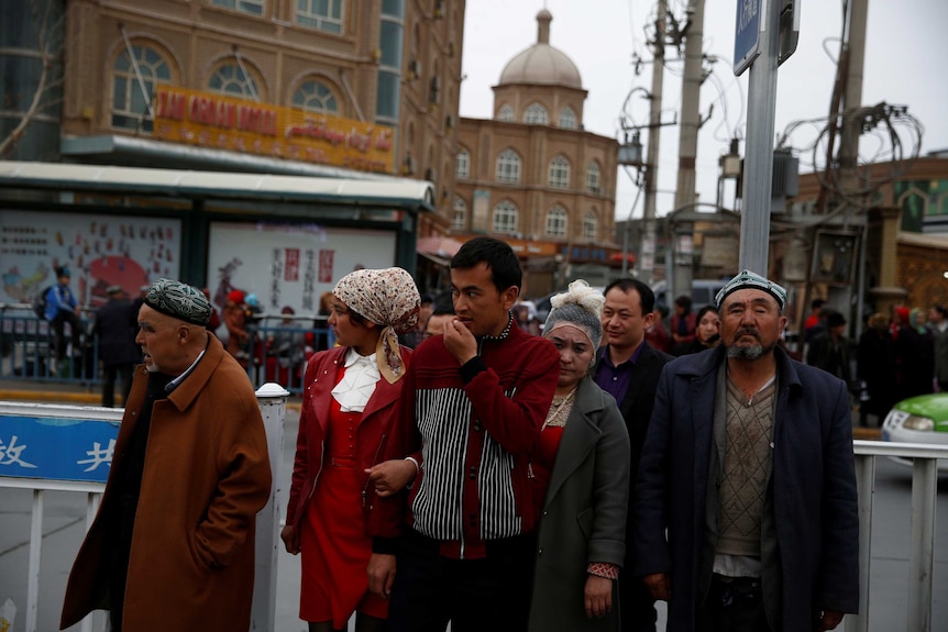 People cross a street in the old town of Kashgar.
