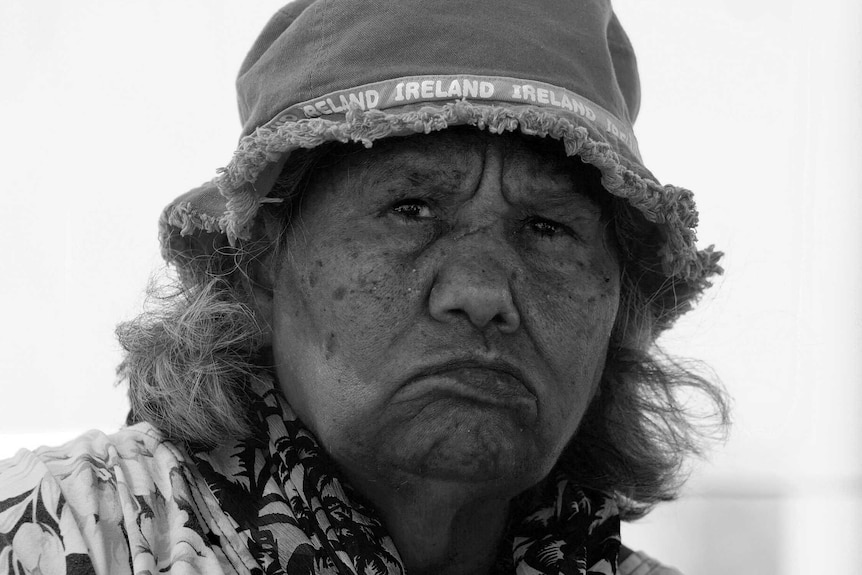 A black and white portrait of Ngarluma elder Pansy Hicks wearing a hat.