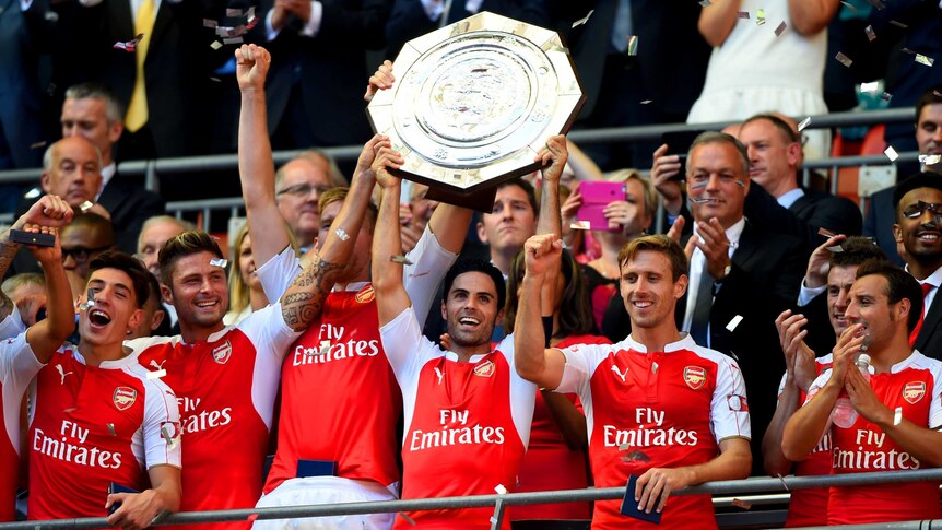 Arsenal captain Mikel Arteta lifts trophy after his team's win over Chelsea in Community Shield.