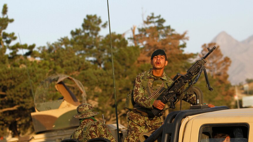 Afghan National Army soldiers arrive at the site of a Taliban attack