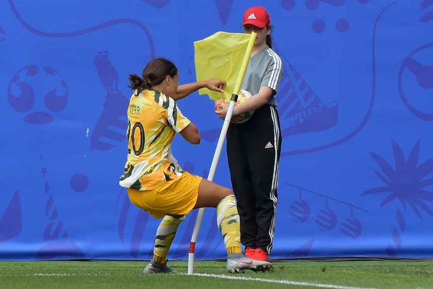 Sam Kerr boxes the corner flag.