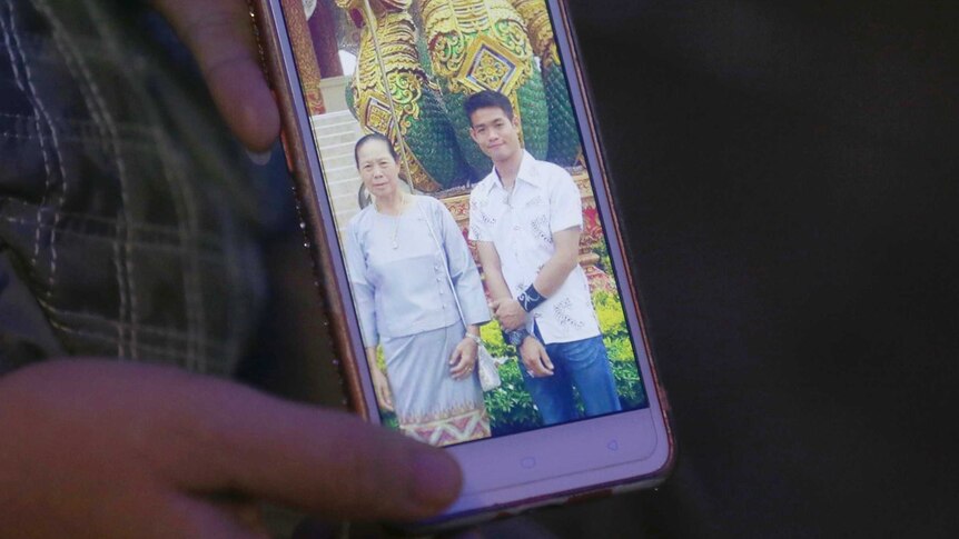 A mobile phone screen shows a photo of Ekapol Chanthawong and his grandmother.