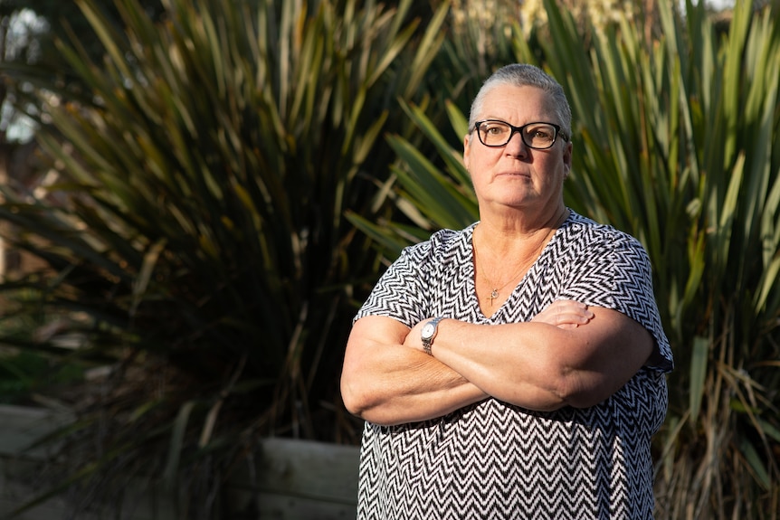 Leonie Riley stands in front of a tree with her arms folded.