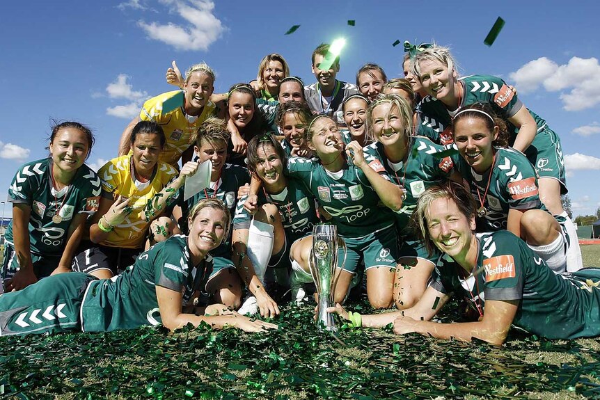 Canberra celebrates with the W-League trophy